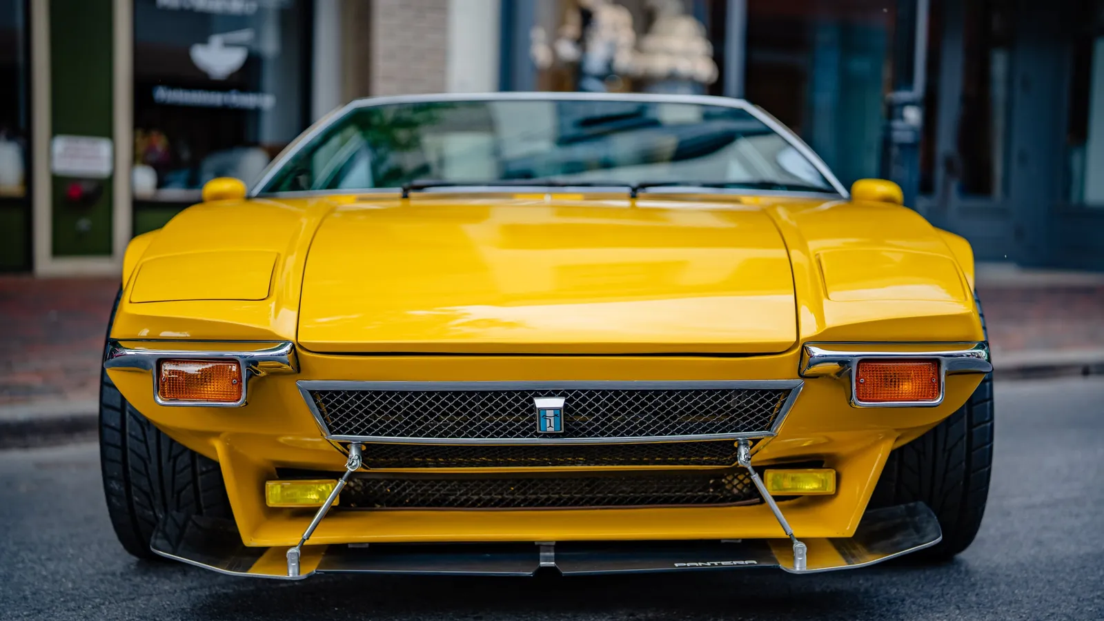Yellow classic sports car on a city street